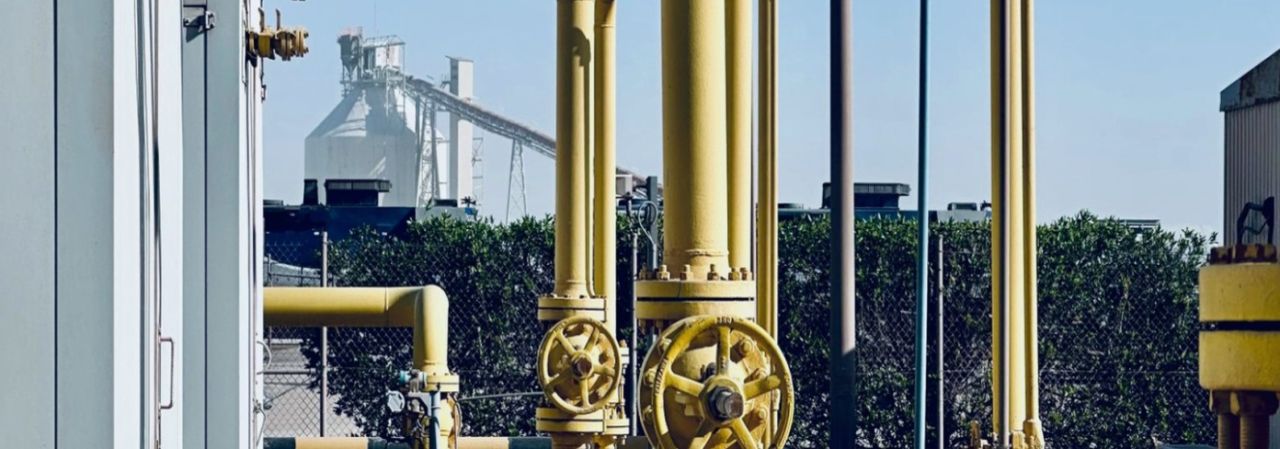 Yellow process pipework and valves at an industrial facility.