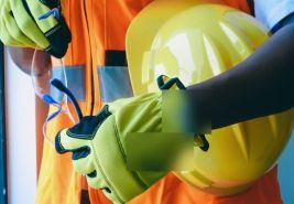 High-visibility clothing, gloves and a hard hat prepared for use.